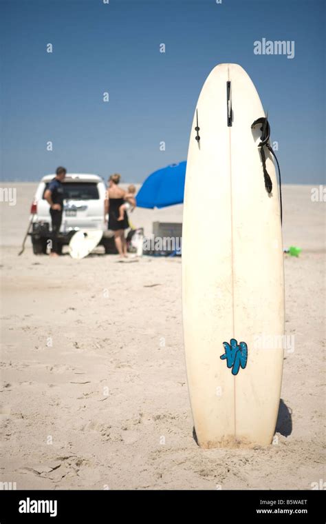Surfboard Stuck In The Sand Stock Photo Alamy