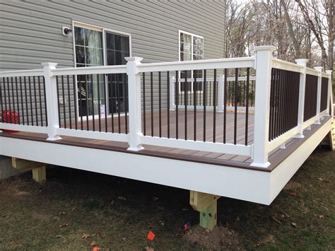 Vinyl railing with black spindles. Fiberon Ipe w/ rosewood feature board, Monument vinyl ...