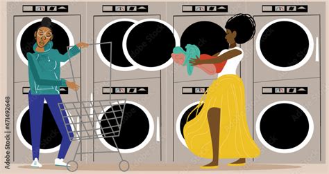 Lesbian Couple In The Laundromat While Partner Pushes Laundry Cart