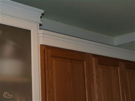Consider adding window and door trim. Adding Crown Molding On Kitchen Cabinets - General DIY ...