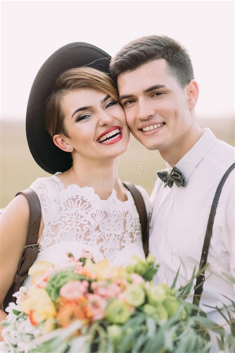 The Smiling Vintage Dressed Newlyweds And Standing Head To Head And