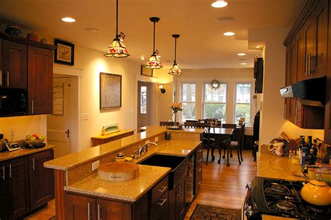 Main cabinets were painted in white and topped with flat nosed marble for a more modern profile and the large kitchen island goes for a solid teak wood finish. Kitchen Bathroom Remodel | Colony Home Improvement