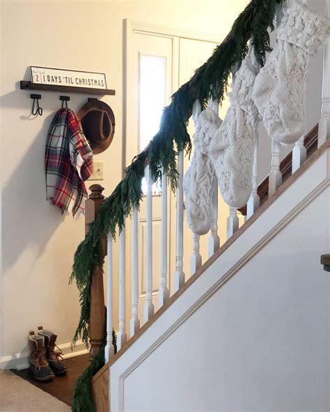 Looking for staircase design inspiration? Christmas stair rail decor/ Christmas decor/ knit stocking ...