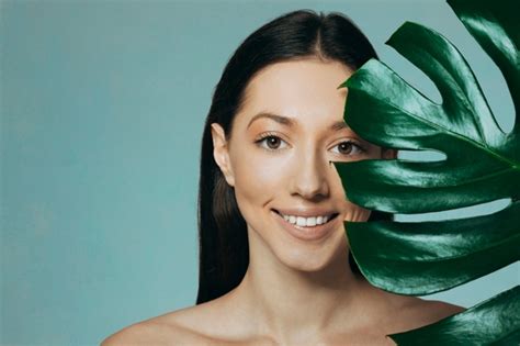 Free Photo Brunette Girl Posing With Exotic Leaves