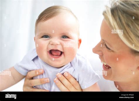 Woman Holding Baby And Laughing Baby Laughing With Mouth Open Stock