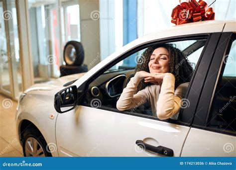 Smiling Happy Woman Leaning On The Window Of Her Car Sitting In The