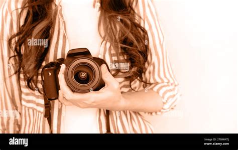 Photographer Holding Dslr Camera Image Toned In Peach Fuzz Color Of