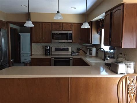 I wouldn't try to remove it. Remove soffit and add cabinets above or add shelving below ...