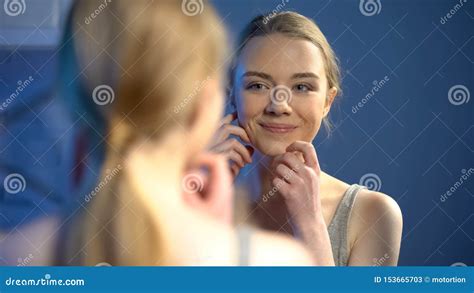 Young Smiling Lady Looking At Mirror Reflection Happy With Skin
