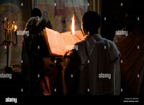 Rear View Of A Monk Reading The Bible In A Church Medhane Alem Church