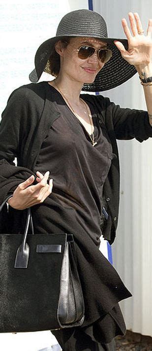 Who Made Angelina Jolies Brown Aviator Sunglasses And Black Tote