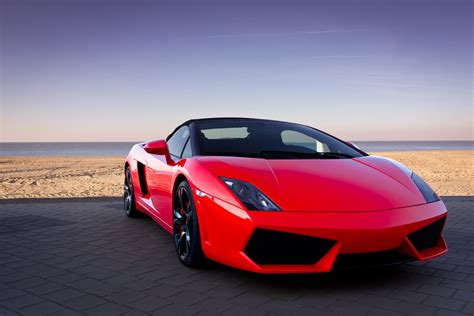 Used cars dealers new cars dealers. Red sports car at sunset beach | Car Title Loans California