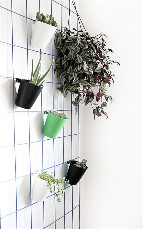 The wood hanging from the ceiling forms a backdrop for which the plants and lights can hang from. Make This: Super Easy DIY Hanging Plant Wall | Wall plant ...