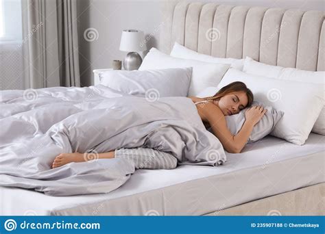 Beautiful Woman Sleeping In Comfortable Bed With Silky Linens Stock