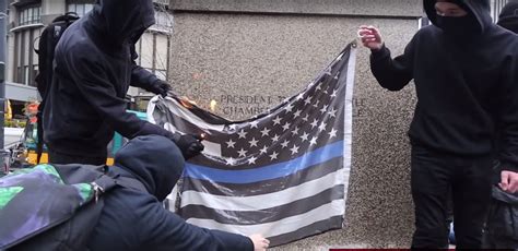 seattle police officer responds   burning   flag