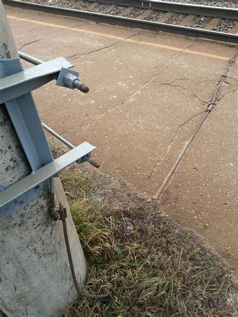 A Metal Rod Connecting A Railroad Track To A Pole No Electronics No