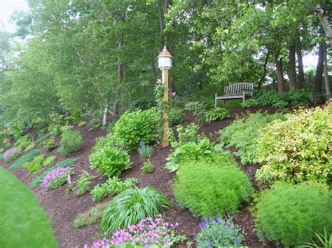 Fix up your lawn (and amp up your curb appeal) with these easy front and backyard landscaping improvements. Slope landscaping | Sloped garden, Backyard hill ...
