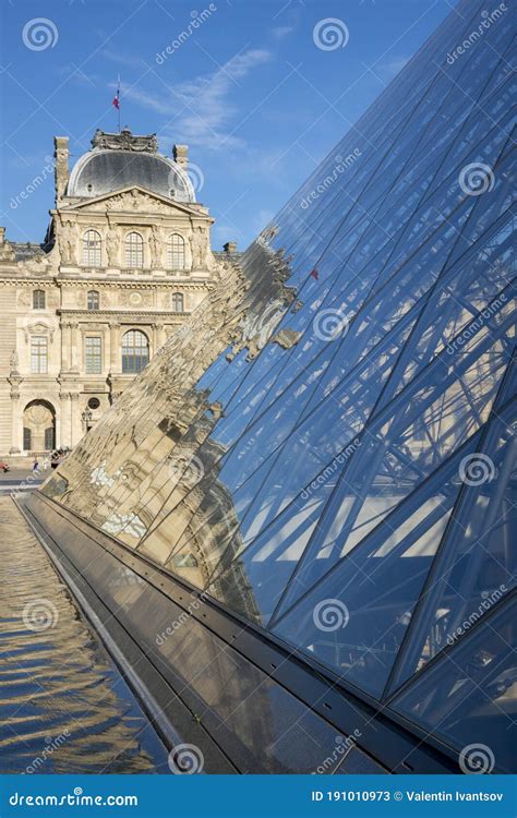 Reflection Of The Louvre Building In The Glass Pyramid Of The Louvre