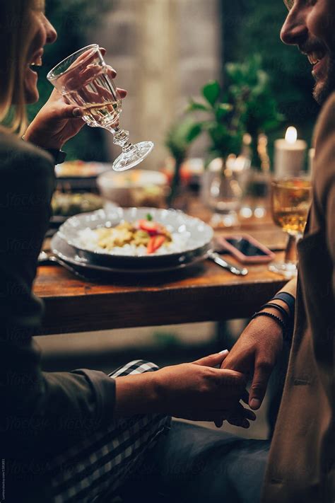 Couple Holding Hands At The Dinner By Lumina For Stocksy United