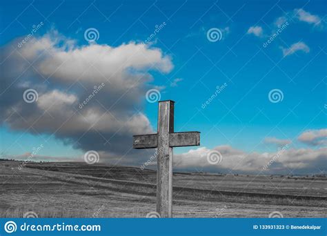 Simple Oak Catholic Cross In Black And White Blue Sky With Stormclouds