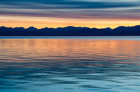 Premium Photo Beautiful Red Sunset Over The Lake With Mountain