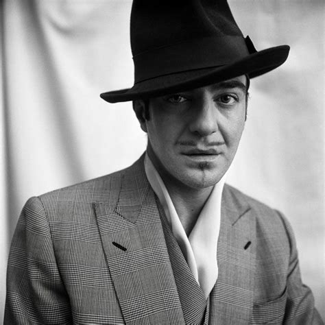 A Man In A Suit And Hat Poses For A Black And White Photo