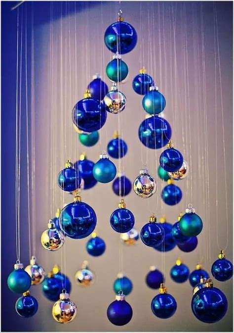 A Blue Christmas Tree With Ornaments Hanging From It