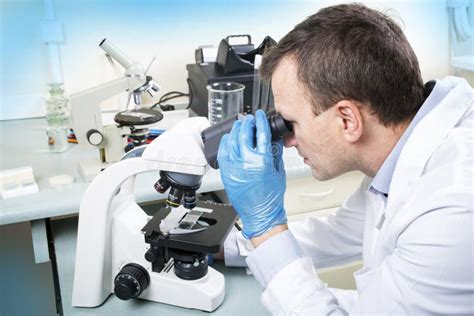 Scientist Looking Through Microscope In Laboratory Stock Image Image