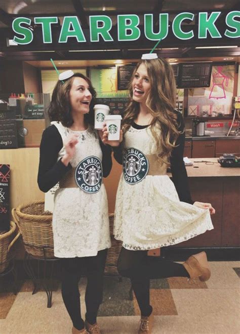 Two Women Dressed In Starbucks Outfits Holding Coffee Cups