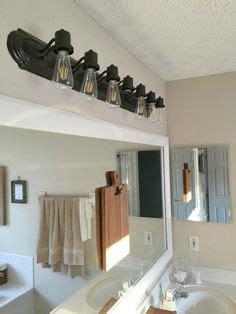 Remove the mounting screws from the light fixture and pull it away from the wall. How to Update Bathroom Lighting (it's as easy as changing ...