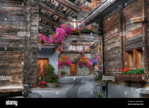 Traditional Wooden Chalets In The Picturesque Swiss Village Of Evolene