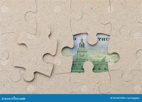 Missing Puzzle Piece and Framed US Dollars. Background with Copy Space
