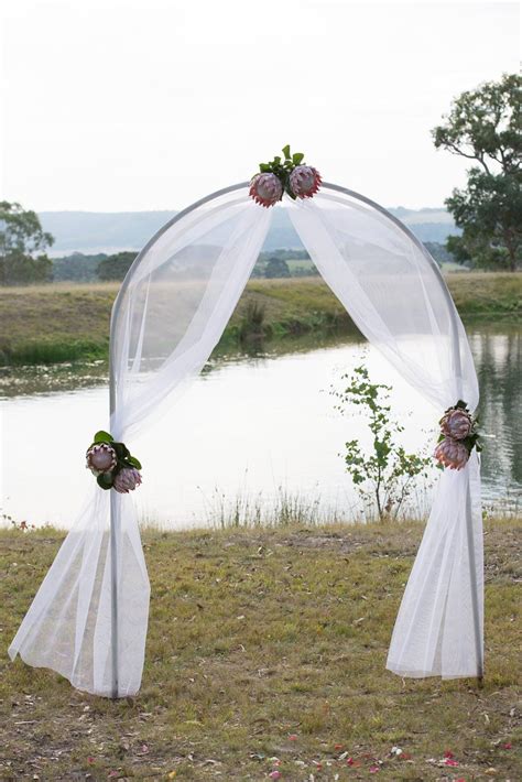 Gorgeous Ceremony Arch Decorated With Tulle And King Proteas Weddings