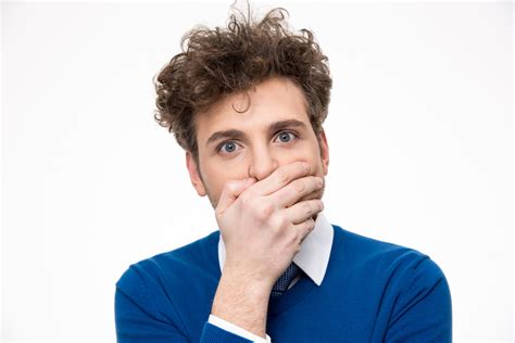 Handsome Man Covering His Mouth Over White Background Royalty Free