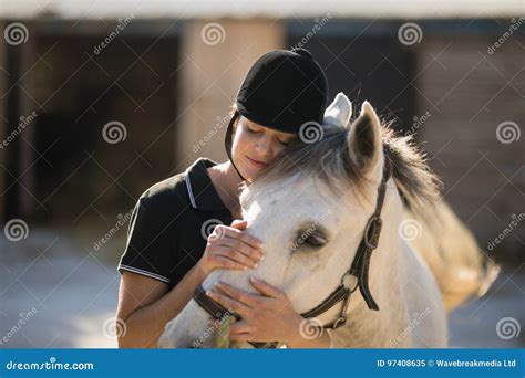 Female Jockey Riding Horse At Barn Editorial Photo