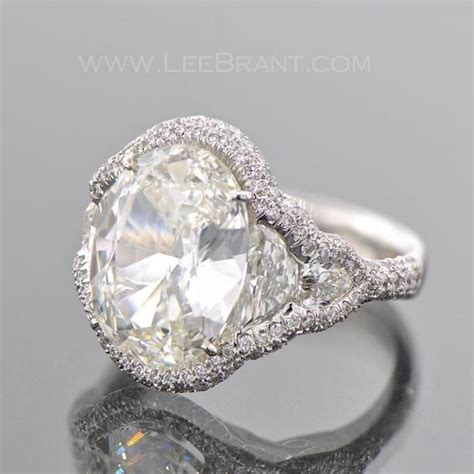 Get inspired by our collection of complete engagement rings. Halo style oval engagement ring with double side stones ...
