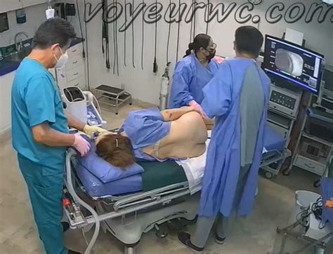 Voyeur WC A Patient Lies On Their Side While A Gastroenterologist