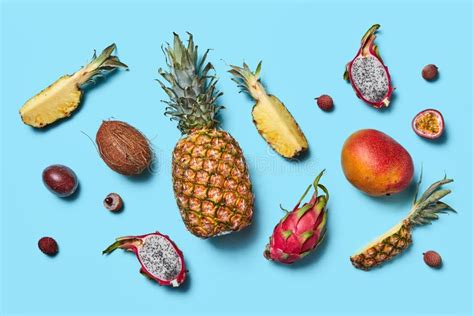 Many Different Exotic Fruits Whole And Halves Presented On A Blue