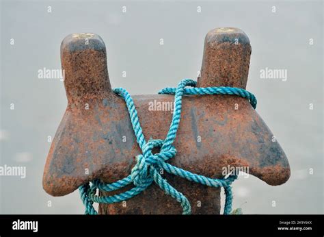 Blue Synthetic Mooring Rope Wound Round Wound Weathered Mooring Bollard