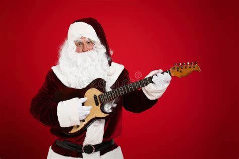 Santa Claus Playing Electric Guitar On Red Background Christmas Music