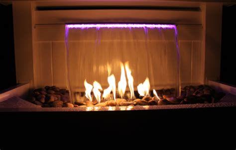 You may wonder how you can have fire mixed with water without the liquid extinguishing it. waterfall with fire | Landscaping supplies, Fire ...