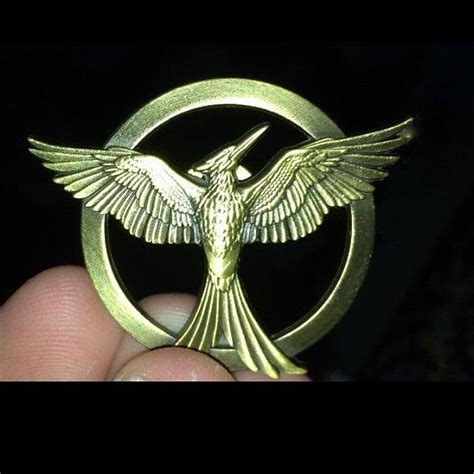 a small gold ring with a bird on it