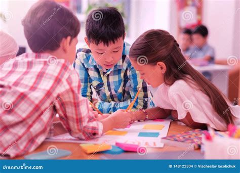 Children Working On Their School Project Together Stock Photo Image