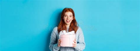 Surprised Redhead Girl Receiving Valentines T Holding Box With