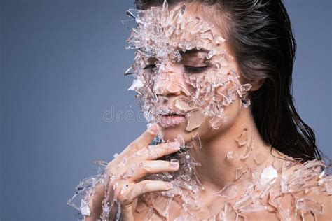 Female Face Covered With A Lot Small Pieces Of Glass Or Ice Stock Photo
