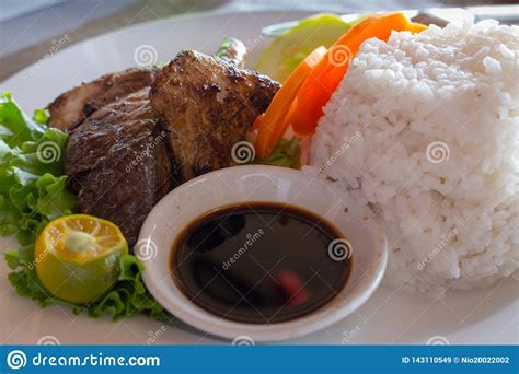 It doesn't get anymore japanese than that! Grilled Fish And White Rice And Fresh Vegetables And Soy Sauce. Asian Cuisine Concept. Grilled ...