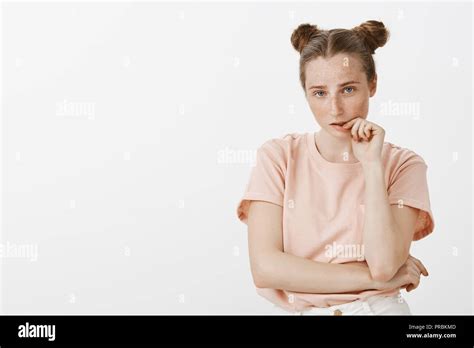 portrait of tired and smart good looking fashionable girlfriend with cute buns hairstyle and