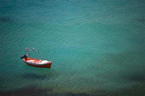 Red Boat On Blue Ocean During Daytime Photo Free Boat Image On Unsplash