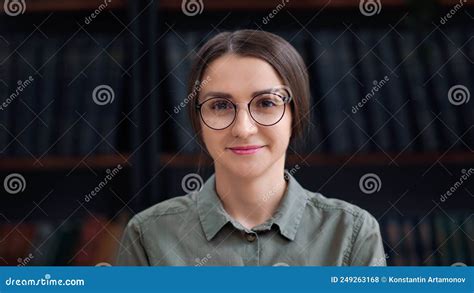Cute Librarian Woman In Eyeglasses Smiling Posing At Bookshelves Bookcase Bookstore Library