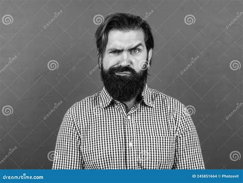 Serious Mature Teacher On Background Of Blackboard Brutal Bearded Man